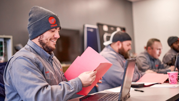 Technicians working on laptops