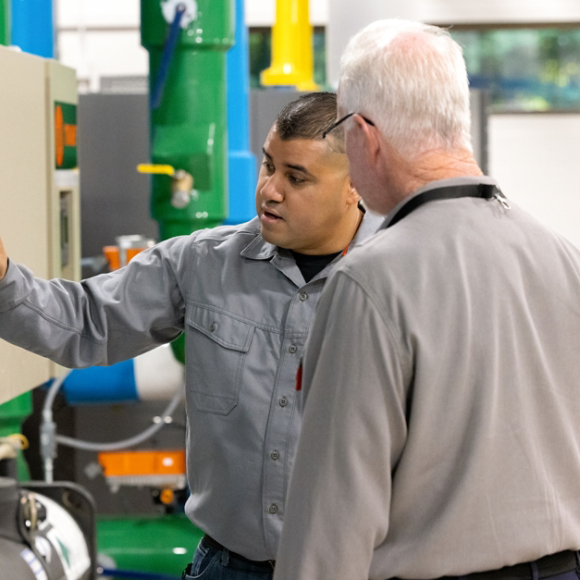 Technicians working with unit
