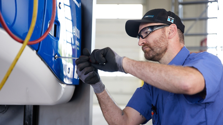 Male service technician working on unit