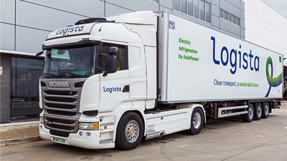Logista truck and trailer with AxlePower refrigeration unit from Thermo King parked in front of a building