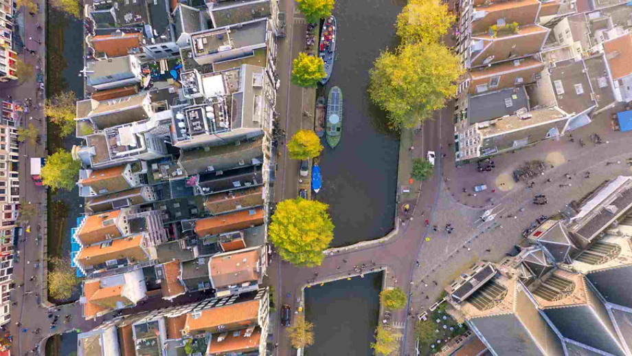 aerial view of boats on a canal running through a city