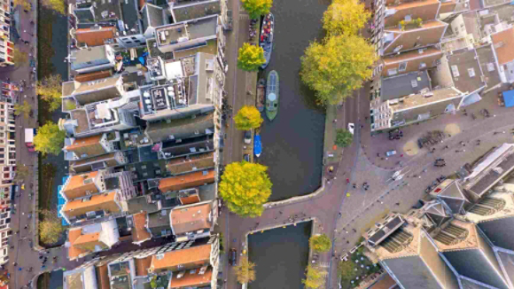 aerial view of boats on a canal running through a city