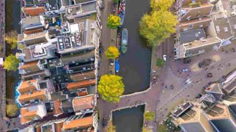 aerial view of boats on a canal running through a city