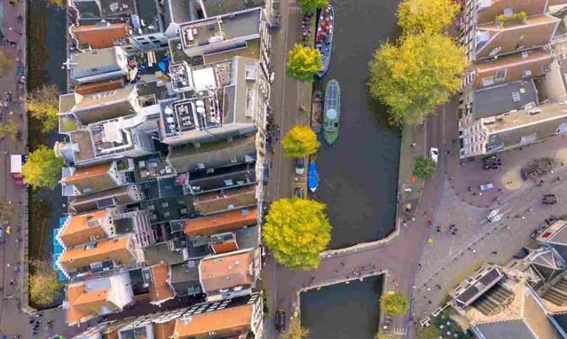 aerial view of boats on a canal running through a city