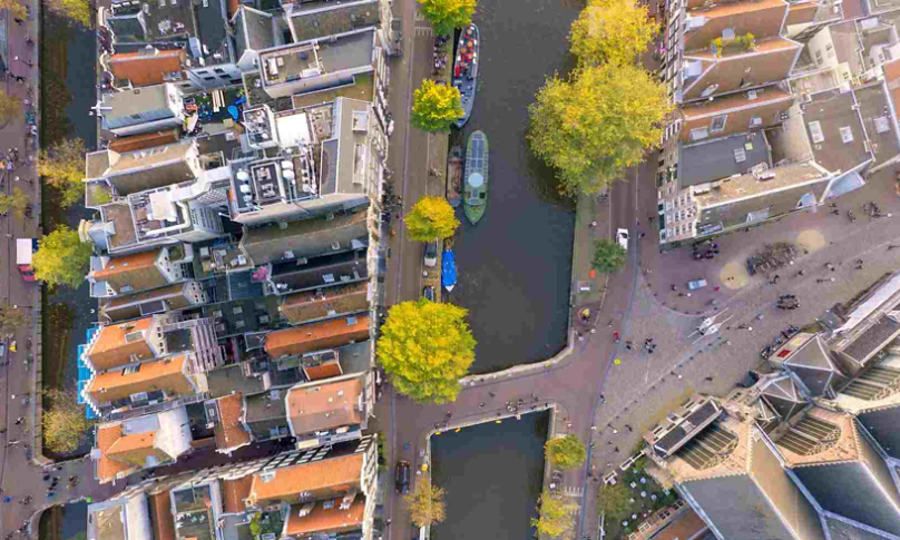 aerial view of boats on a canal running through a city