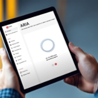 Worker holding digital tablet with blank white screen in warehouse