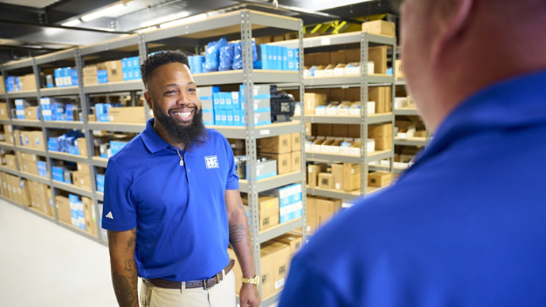 Thermo King dealer employees in conversation in parts warehouse