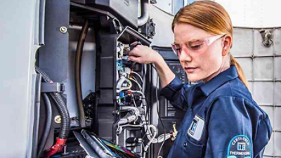 female maintenance technician working on a Thermo King unit