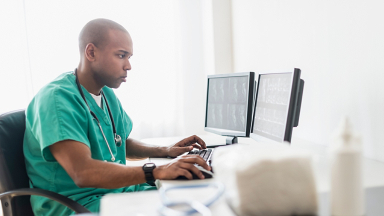 nurse looking at hospital screen