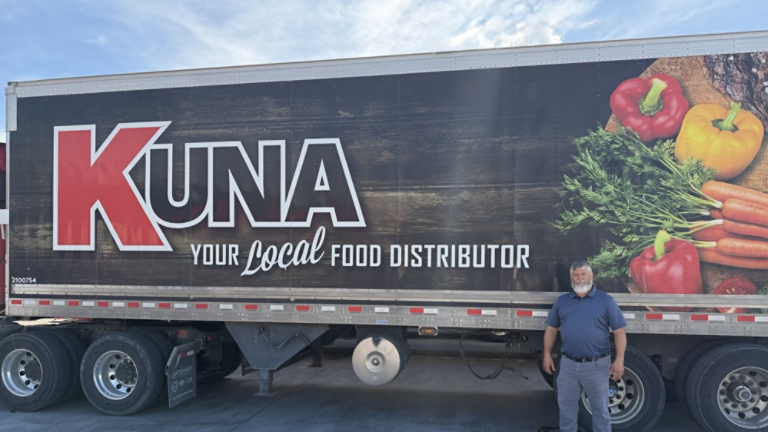 Man Standing in front of KUNA Truck