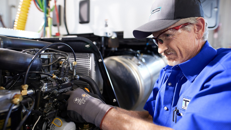 Male service technician in hat working on equipment