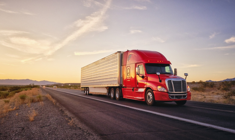 Truck with Trailer Driving during Sunset