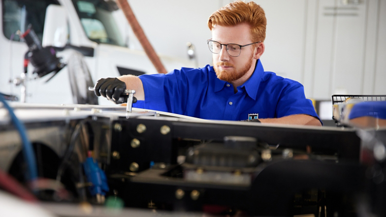 Thermo King service technician working on a transport refrigeration unit