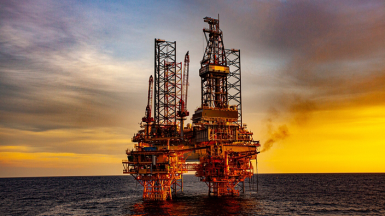 oil drilling rig at sunset