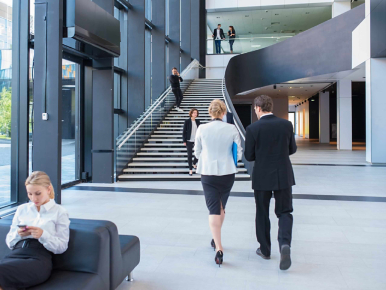 people walking through office space