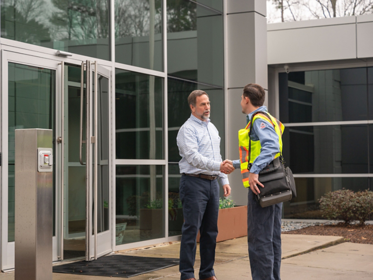 Technician Greeting Employee at Door