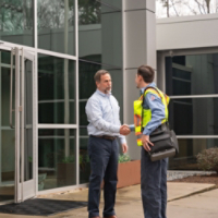 Technician Greeting Employee at Door