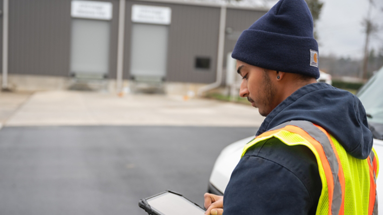 Technician Checking Tablet
