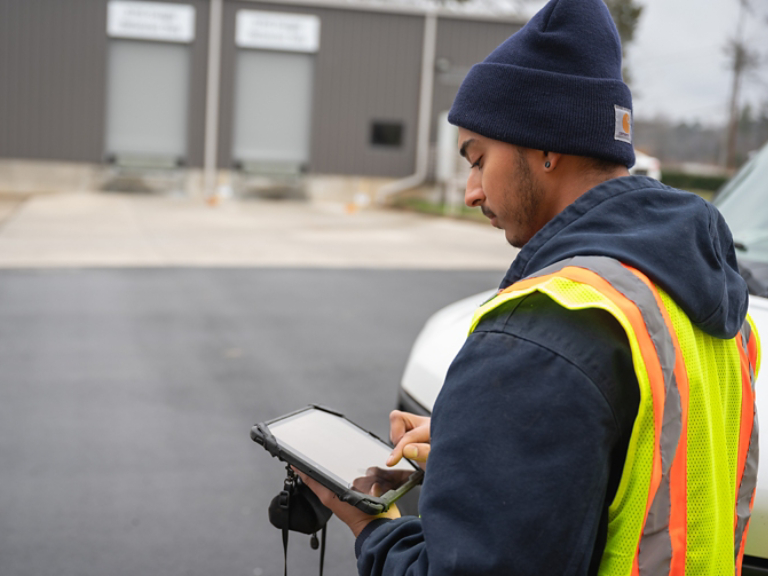 Technician Checking Tablet