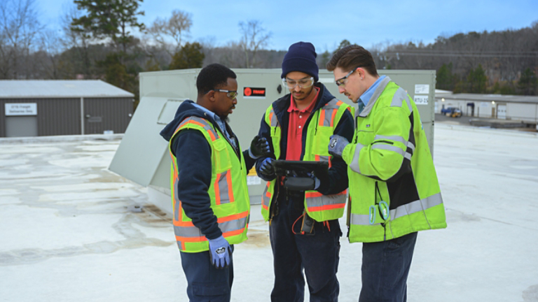 Symbio Technicians Working Together on roof