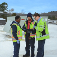 Symbio Technicians Working Together on roof