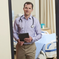 Doctor in Hospital Room with Tablet