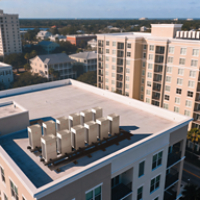 Multiple outdoor Trane¬Æ / Mitsubishi ElectricVRF units on roof of a high rise building
