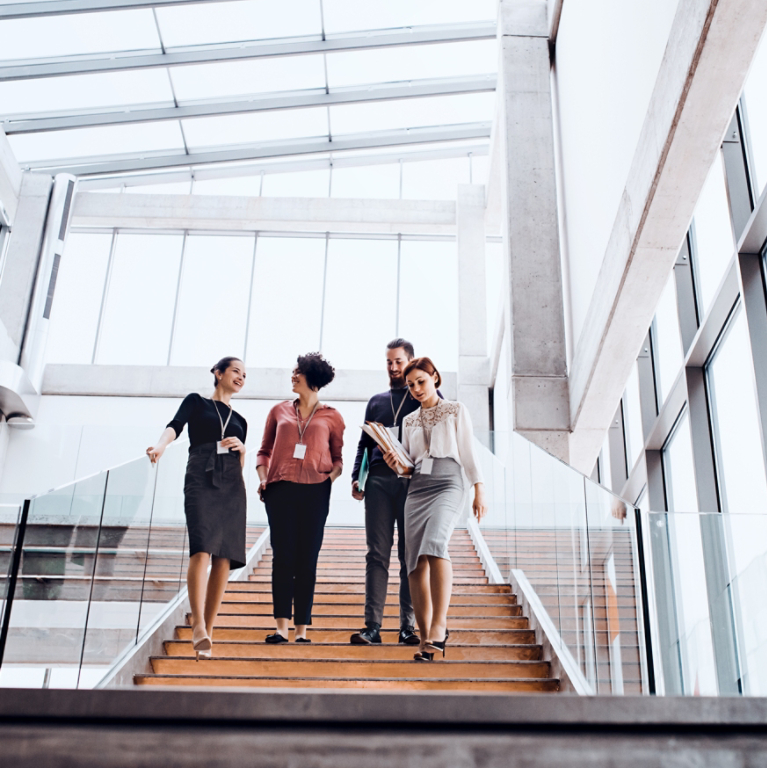 Group of young business people walking down the stairs