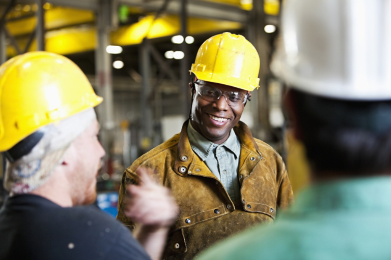 Three industrial workers in hard hats