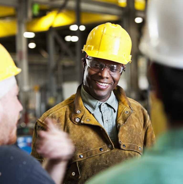 Three industrial workers in hard hats