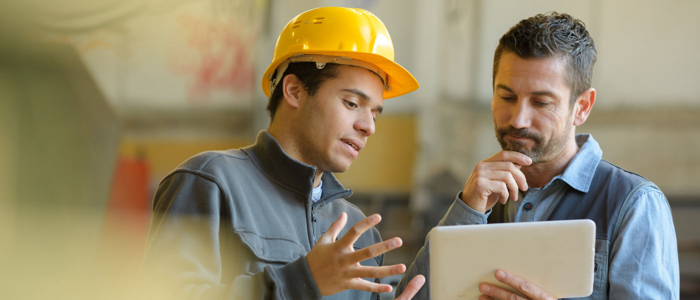 boss and worker checking results on the tablet