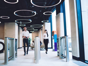 Confident coworkers passing checkpoint at workplace