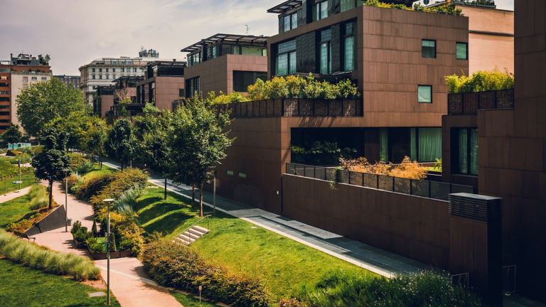 Modern residential buildings in the public green area. Real estate houses in Milan, Italy.