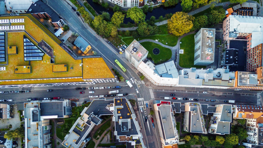 Downtown intersection surrounded by buildings and nature.