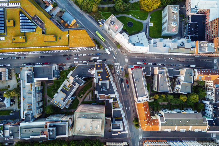 Downtown intersection surrounded by buildings and nature.