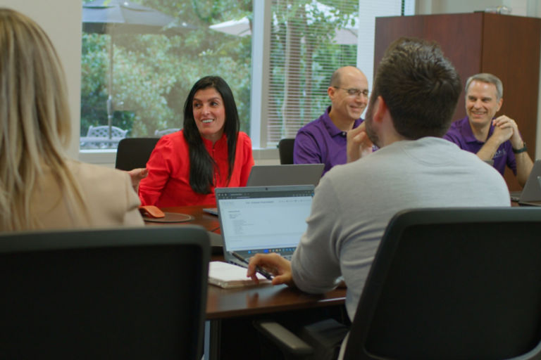 Alessandra Hammond leading her team in a brainstorming session