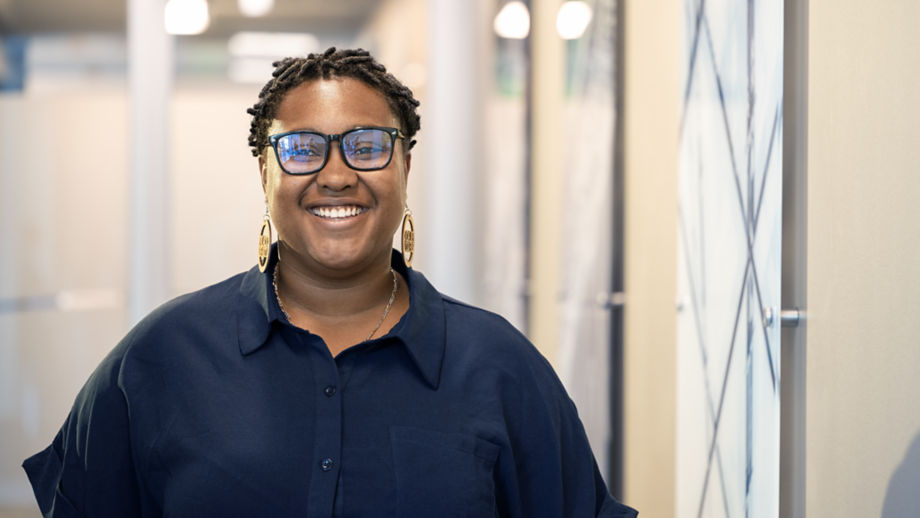 Female employee laughing in hallway