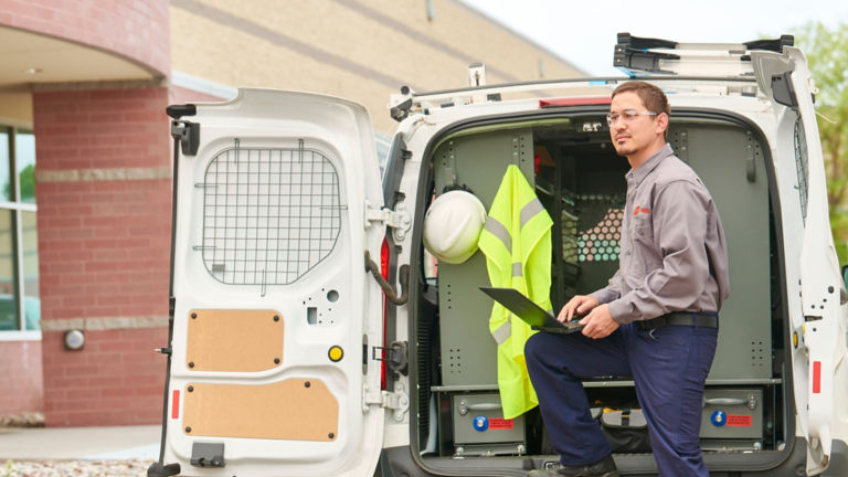 Trane technician at service vehicle