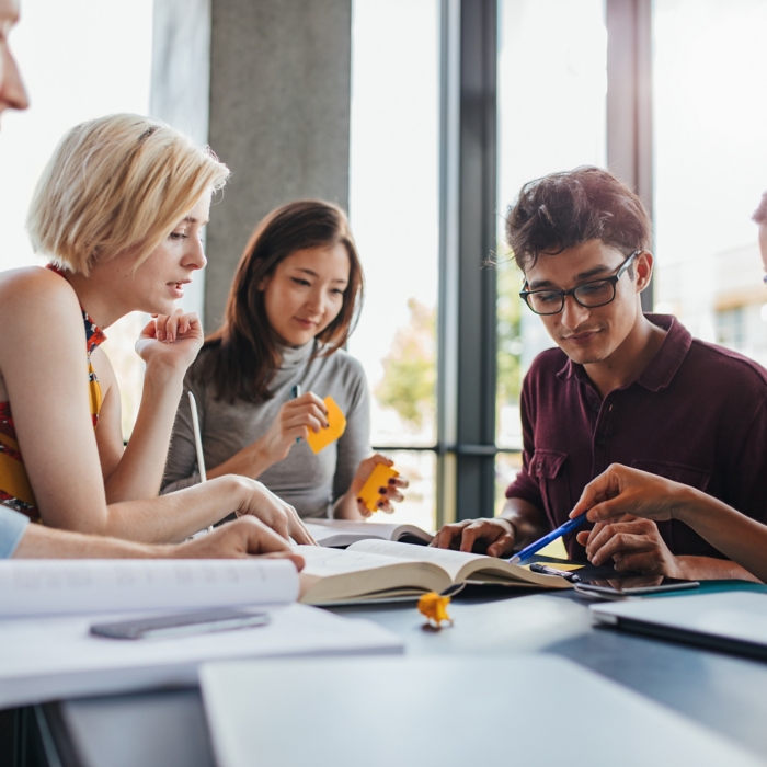Diverse group of students studying at library