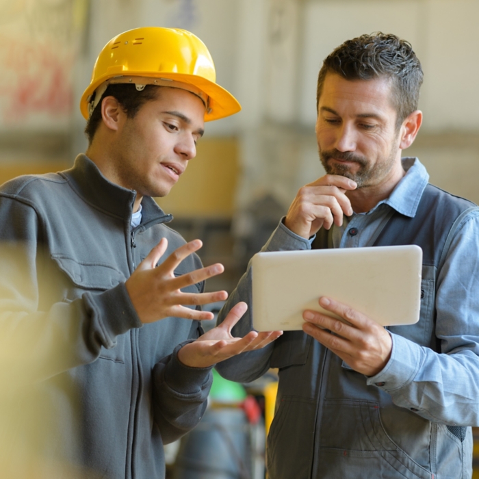 boss and worker checking results on the tablet