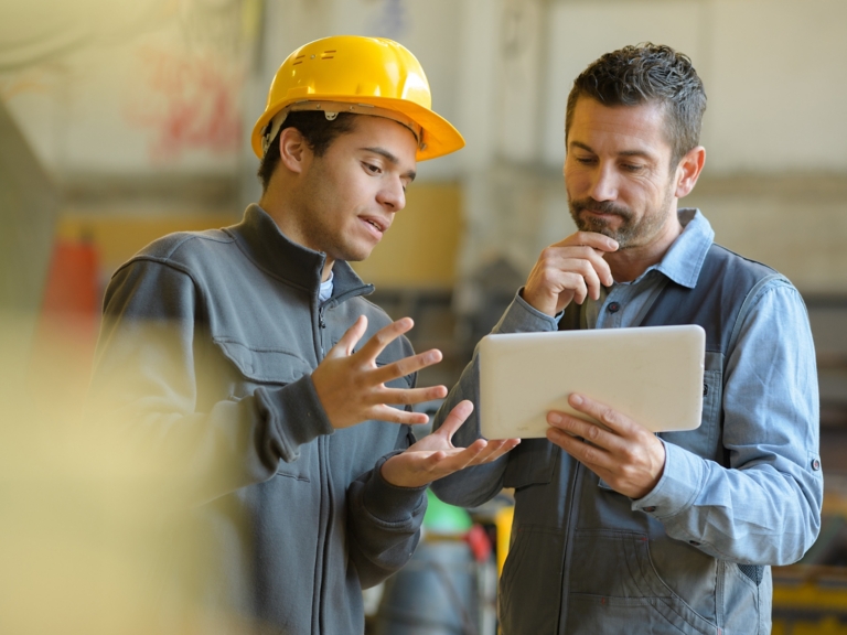 boss and worker checking results on the tablet