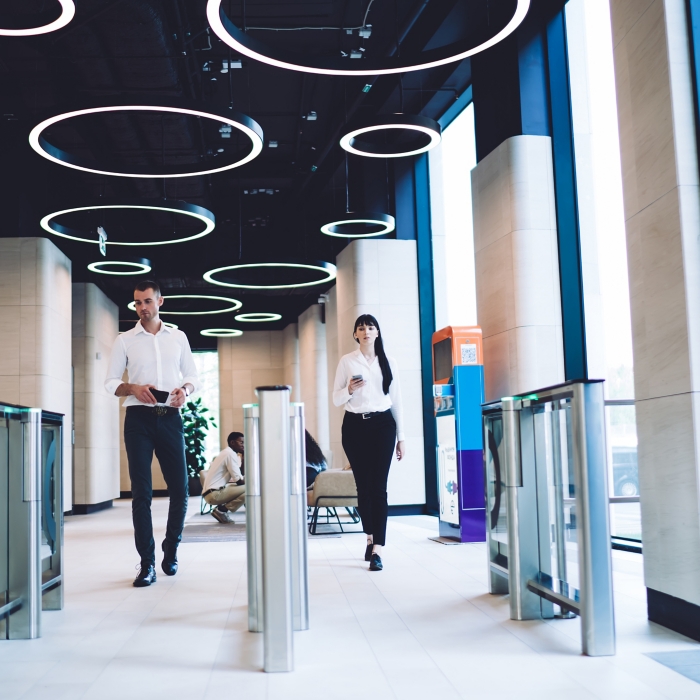 Confident coworkers passing checkpoint at workplace
