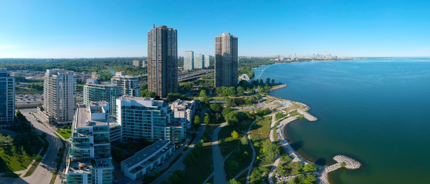 Artistic creative view of Humber Bay Shores Park city view and green space with skyline cityscape, azure lake Ontario. Skyscrapers over The Queensway on sunset at summer, Etobicoke, Ontario, Canada