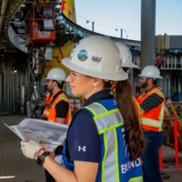 Chrystelle Le Roux on-site with building plans