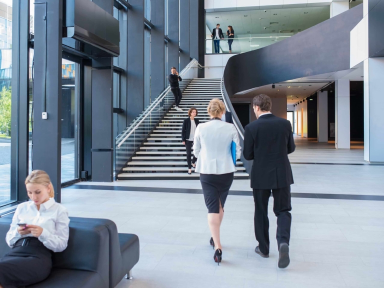 people walking through office space