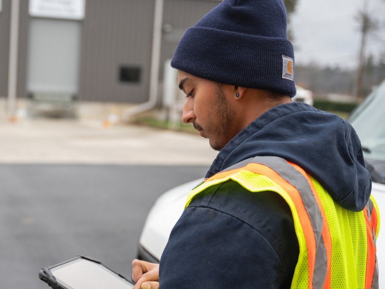 Technician Checking Tablet