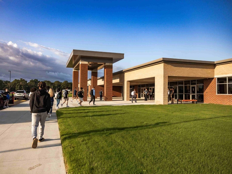 people walking into school