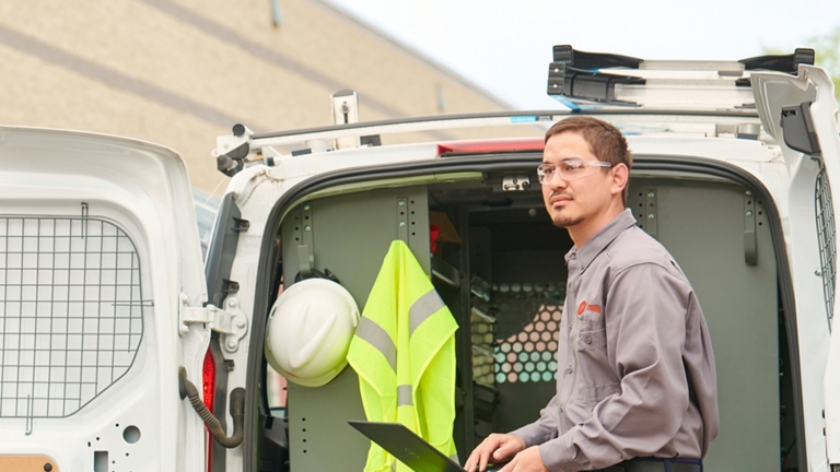 Trane technician at service vehicle