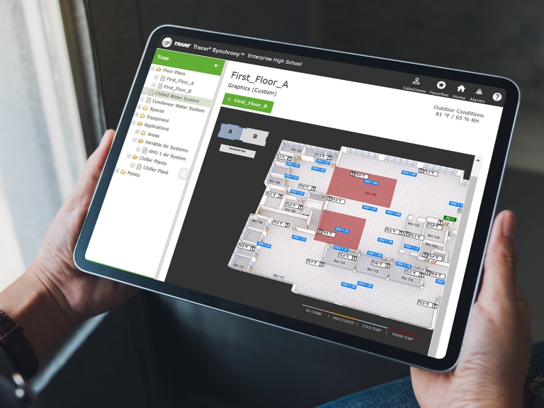 Mockup image of a woman holding black tablet pc with blank white screen in cafe